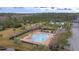 Aerial view of a pristine community pool and recreational area surrounded by lush trees, with lounge seating and a clubhouse at 2136 Baldwin Park Dr, Mount Pleasant, SC 29466