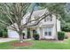 Traditional home with a two-car garage, a front yard with mature trees and lush green lawn, and tasteful landscaping at 2136 Baldwin Park Dr, Mount Pleasant, SC 29466