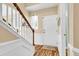 Bright foyer with wood floors, white wainscoting, stairs, and front door at 2136 Baldwin Park Dr, Mount Pleasant, SC 29466