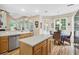 Bright eat-in kitchen featuring an island, stainless steel dishwasher, and sun-drenched breakfast nook at 2136 Baldwin Park Dr, Mount Pleasant, SC 29466