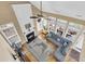 A top-down view of an open-concept living room with a fireplace, large windows, hardwood floors, and comfortable seating at 2136 Baldwin Park Dr, Mount Pleasant, SC 29466