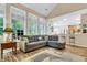 Cozy living room featuring a comfortable sectional sofa, hardwood floors, and large windows that provide ample natural light at 2136 Baldwin Park Dr, Mount Pleasant, SC 29466