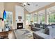 Bright and airy living room featuring a cozy fireplace, large windows, hardwood floors, and a comfortable sectional couch at 2136 Baldwin Park Dr, Mount Pleasant, SC 29466