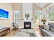 Bright and airy living room with a cozy fireplace, large windows, and hardwood floors and comfortable seating at 2136 Baldwin Park Dr, Mount Pleasant, SC 29466