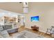 Spacious living room with hardwood floors, a sectional sofa, and an open view to the kitchen and the home's upper level at 2136 Baldwin Park Dr, Mount Pleasant, SC 29466