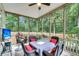 Comfortable screened porch with seating and a view of the trees at 2136 Baldwin Park Dr, Mount Pleasant, SC 29466
