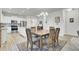 Open dining area adjacent to a kitchen, featuring a wooden table set and stylish area rug at 222 Hayworth Rd, Summerville, SC 29486