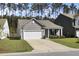 Inviting single-story home with a two-car garage and a well-maintained lawn in a quiet neighborhood at 222 Hayworth Rd, Summerville, SC 29486