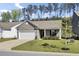 Charming single-story home with a two-car garage, manicured lawn, and beautiful landscaping at 222 Hayworth Rd, Summerville, SC 29486
