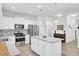 Well-equipped kitchen with stainless steel appliances, white cabinetry, granite counters, and a functional center island at 222 Hayworth Rd, Summerville, SC 29486
