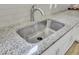 Close-up of a stainless steel kitchen sink with granite countertops and stylish faucet at 222 Hayworth Rd, Summerville, SC 29486