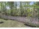 A wooded backyard featuring a rustic wooden fence, manicured landscaping and a private backyard at 227 Lipman St, Summerville, SC 29483