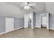 Bedroom featuring three doors, neutral walls, a ceiling fan, and spacious closet with shelving at 227 Lipman St, Summerville, SC 29483