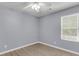 Bedroom features neutral walls, modern ceiling fan, and a window with views of the outside at 227 Lipman St, Summerville, SC 29483