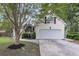 Side view of home with spacious two-car garage, clean driveway, and tidy landscaping at 227 Lipman St, Summerville, SC 29483