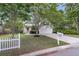 Inviting home with a lush green lawn, a white picket fence, and a freshly paved driveway at 227 Lipman St, Summerville, SC 29483