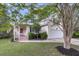 Charming home featuring a well-maintained lawn, tidy landscaping, and an attached two-car garage at 227 Lipman St, Summerville, SC 29483