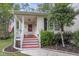 Inviting covered front porch with red stairs and a charming American flag for added curb appeal at 227 Lipman St, Summerville, SC 29483