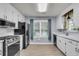 Efficient kitchen with stainless steel appliances, light cabinets, and a window view at 227 Lipman St, Summerville, SC 29483