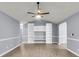 Spacious living room with vaulted ceilings, built-in shelving, and modern ceiling fan at 227 Lipman St, Summerville, SC 29483