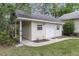 View of outdoor building with white siding, double doors, and manicured landscaping at 227 Lipman St, Summerville, SC 29483