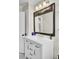 Renovated bathroom features a large mirror above the white vanity and updated lighting at 237 Cypress Dr, Walterboro, SC 29488