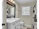 Bright bathroom featuring a white vanity, modern fixtures, and a decorative shower curtain at 237 Cypress Dr, Walterboro, SC 29488