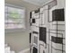 Bathroom features a geometric patterned shower curtain and natural light from the window at 237 Cypress Dr, Walterboro, SC 29488