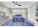 Bedroom with blue rug, tv, and built-in shelves at 237 Cypress Dr, Walterboro, SC 29488