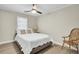 Cozy bedroom featuring a queen bed, ceiling fan and a classic wooden chair at 237 Cypress Dr, Walterboro, SC 29488