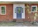 Charming brick home featuring an inviting front door with sidelights and windows flanking each side at 237 Cypress Dr, Walterboro, SC 29488