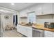 Kitchen with white cabinets, wood countertops, stainless steel dishwasher, and view into the dining area at 237 Cypress Dr, Walterboro, SC 29488