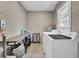 Bright laundry room with white brick and washer and dryer at 237 Cypress Dr, Walterboro, SC 29488