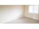 Bright bedroom with neutral carpet, window with blinds, and cream-colored walls at 2402 Riverridge Ct, Moncks Corner, SC 29461