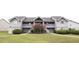 Gray two-story condo building with well-maintained lawn and mature landscaping at 2402 Riverridge Ct, Moncks Corner, SC 29461