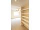 Bright hallway with carpet flooring, built-in shelving, and view of the living room at 2402 Riverridge Ct, Moncks Corner, SC 29461