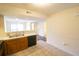 Open kitchen with stainless steel sink, wood cabinets, and view of the living area at 2402 Riverridge Ct, Moncks Corner, SC 29461