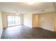 Bright living room with sliding doors to the patio, wood-look floors, and neutral walls at 2402 Riverridge Ct, Moncks Corner, SC 29461