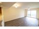Spacious living room with modern floors, ceiling fan, and sliding glass doors to a patio at 2402 Riverridge Ct, Moncks Corner, SC 29461