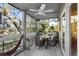 Relaxing screened-in balcony with comfortable seating and ceiling fan, overlooking trees at 2413 Racquet Club Dr, Seabrook Island, SC 29455