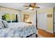 Relaxing bedroom featuring a decorative four-poster bed, hardwood floors, and ample natural light from the window at 2413 Racquet Club Dr, Seabrook Island, SC 29455