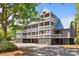 Charming three-story condo with multiple balconies and coastal architecture, set amidst lush greenery at 2413 Racquet Club Dr, Seabrook Island, SC 29455