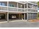 Home features a garage and parking area underneath the elevated living spaces at 2413 Racquet Club Dr, Seabrook Island, SC 29455