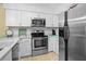 Modern kitchen with stainless steel appliances, white cabinetry, and ample counter space, perfect for cooking at 2413 Racquet Club Dr, Seabrook Island, SC 29455