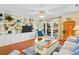 Inviting living room with built-in shelving, hardwood floors, and sliding door access to balcony at 2413 Racquet Club Dr, Seabrook Island, SC 29455