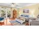 Cozy living room features hardwood floors, comfortable seating, and sliding door access to balcony at 2413 Racquet Club Dr, Seabrook Island, SC 29455