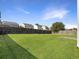 Large, level backyard featuring lush green grass and a wooden fence at 243 Donatella Dr, Goose Creek, SC 29445
