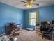Bright bedroom featuring blue walls, neutral carpet, a window, and a ceiling fan with a light at 243 Donatella Dr, Goose Creek, SC 29445