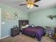 Bedroom features green walls, carpet, ceiling fan with light, Harry Potter decor, and a window at 243 Donatella Dr, Goose Creek, SC 29445