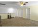 Spacious bonus room featuring neutral walls, carpet, ceiling fan, and three white doors at 243 Donatella Dr, Goose Creek, SC 29445